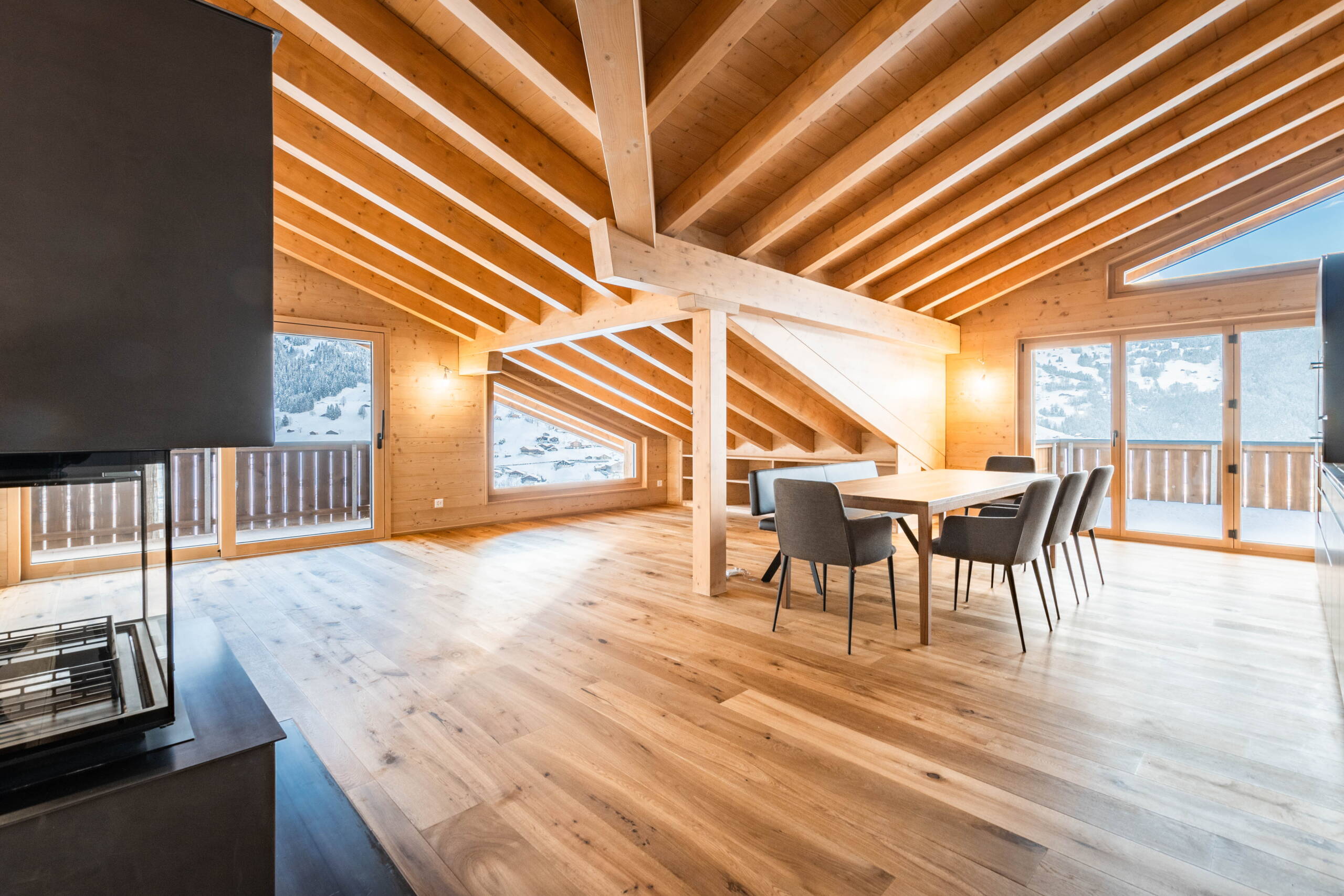 Living room in Chalet WALT with alpine wooden beams and warm interior design